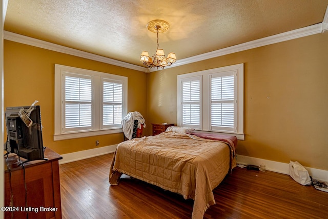 bedroom with ornamental molding, dark hardwood / wood-style floors, and a textured ceiling