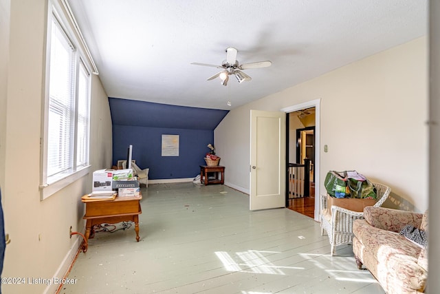 sitting room with ceiling fan and vaulted ceiling