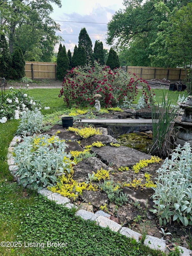 view of yard featuring a garden and fence