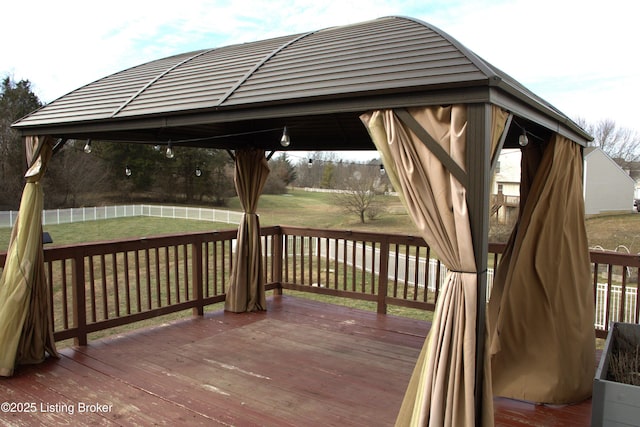 wooden deck featuring a gazebo and a lawn