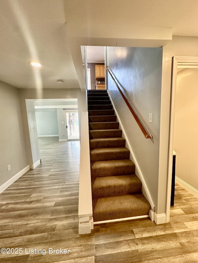 staircase featuring wood-type flooring