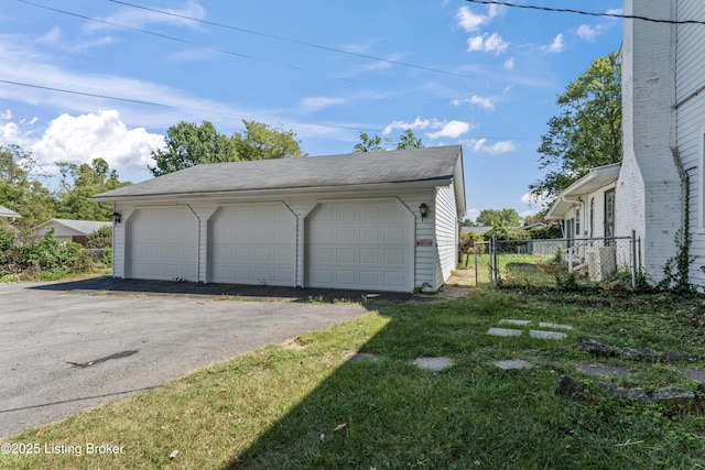 garage featuring a lawn