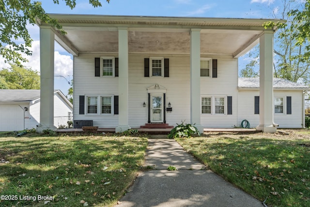 view of front of house featuring central AC and a front yard