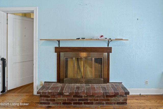 room details with hardwood / wood-style flooring and a fireplace