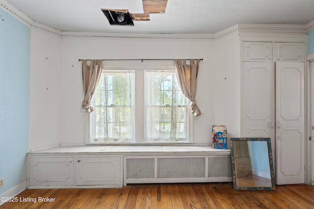 interior space featuring hardwood / wood-style flooring and radiator heating unit