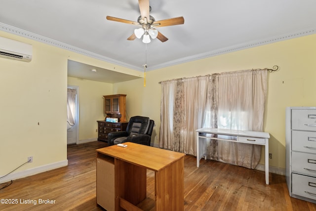 home office with a wall mounted air conditioner, wood-type flooring, ornamental molding, and ceiling fan