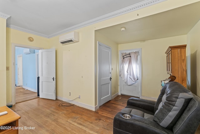 interior space with crown molding, hardwood / wood-style flooring, and a wall unit AC