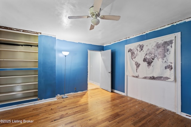 unfurnished bedroom featuring hardwood / wood-style floors and ceiling fan