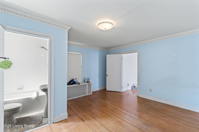 unfurnished room featuring crown molding and hardwood / wood-style floors