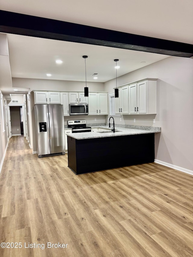 kitchen featuring sink, decorative light fixtures, kitchen peninsula, stainless steel appliances, and white cabinets