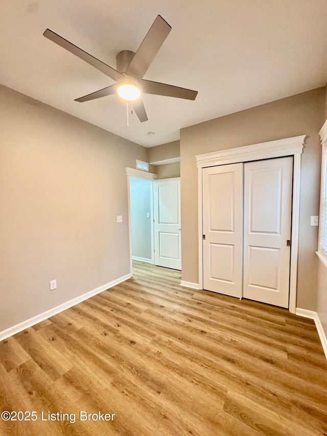 unfurnished bedroom with a closet, ceiling fan, and light wood-type flooring