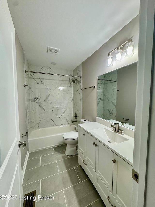 full bathroom with vanity, toilet, and tiled shower / bath