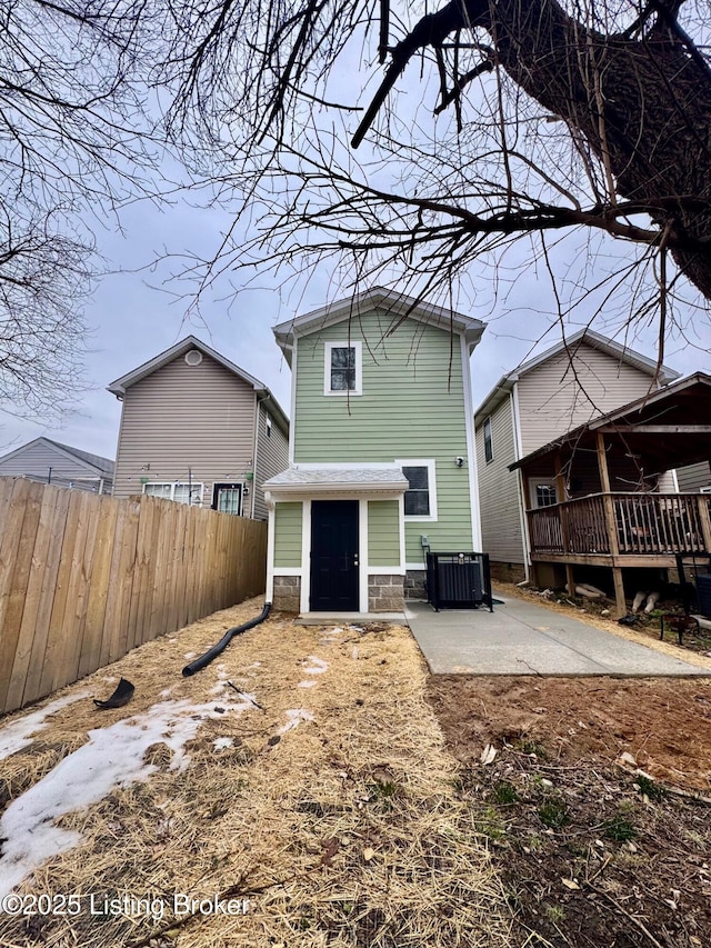 back of house featuring cooling unit, a deck, and a patio area