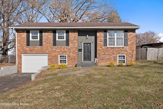 bi-level home with a garage and a front lawn