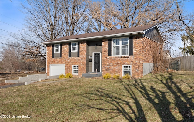 split foyer home with a garage and a front lawn