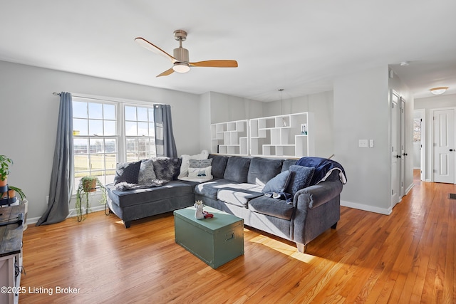 living room with hardwood / wood-style floors and ceiling fan