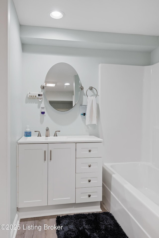 bathroom with vanity, tub / shower combination, and hardwood / wood-style floors