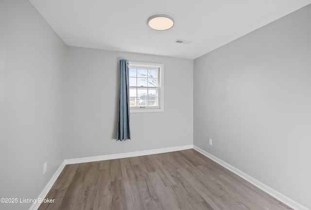 spare room featuring light hardwood / wood-style flooring