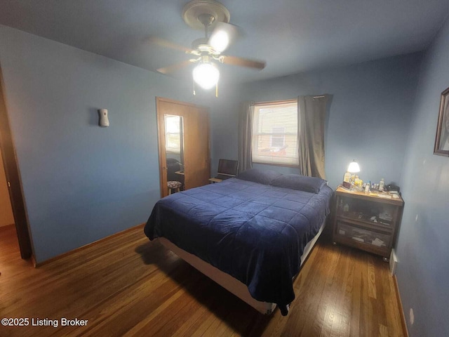 bedroom featuring dark hardwood / wood-style floors and ceiling fan