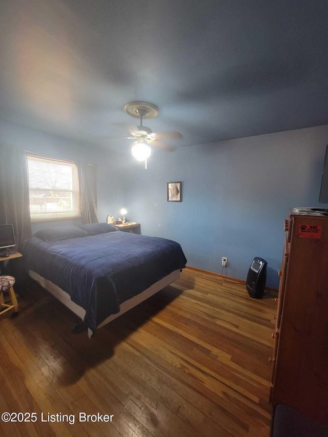 bedroom with hardwood / wood-style flooring and ceiling fan