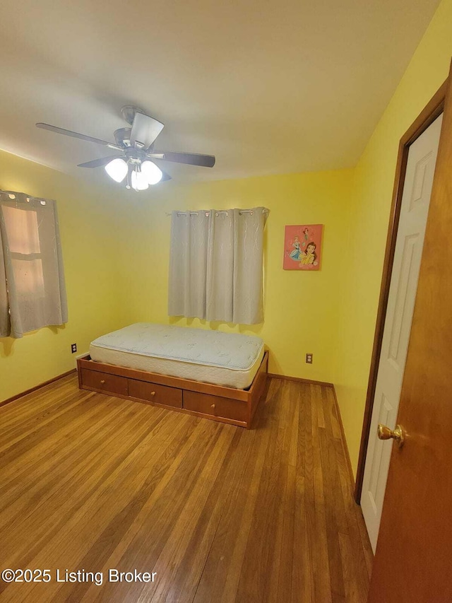 unfurnished bedroom with light hardwood / wood-style flooring and ceiling fan