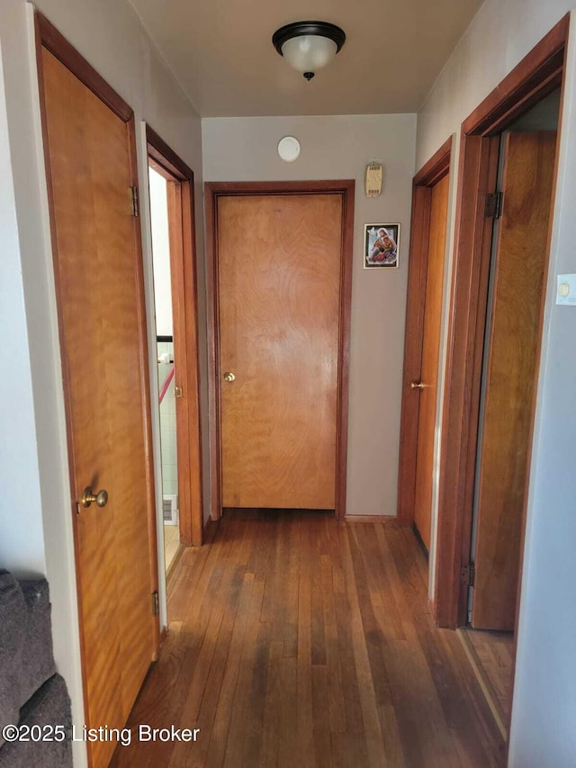 hallway with dark hardwood / wood-style floors