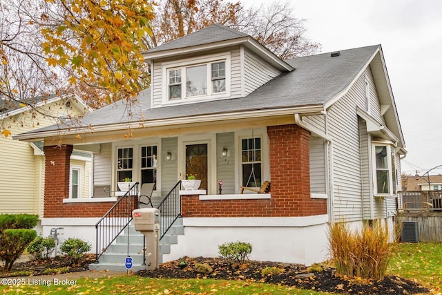 bungalow-style home featuring central AC and covered porch