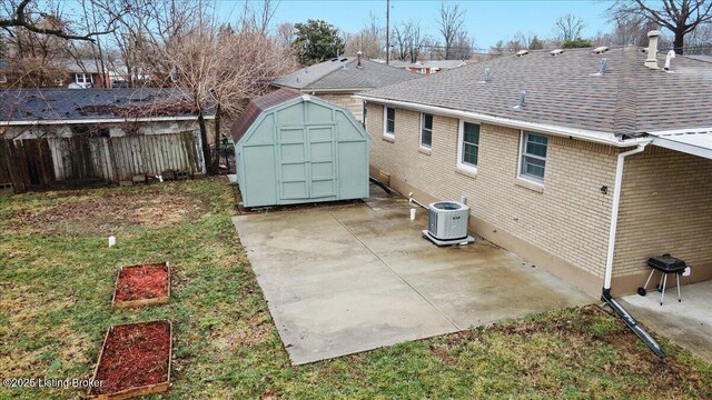 back of house featuring central AC, a patio, a shed, and a lawn