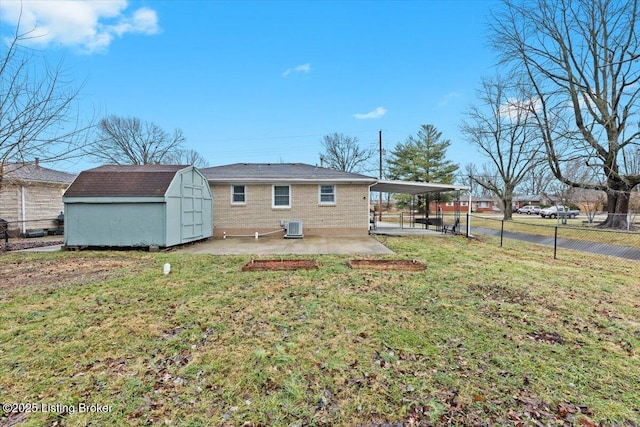 back of house featuring a storage shed, a yard, central AC unit, a carport, and a patio area