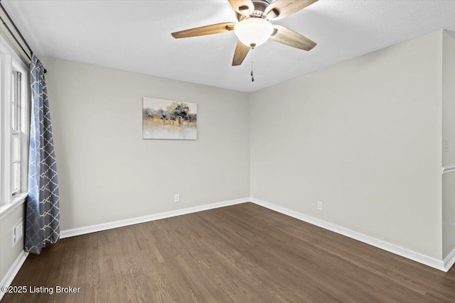 unfurnished room featuring ceiling fan, dark hardwood / wood-style floors, and a textured ceiling