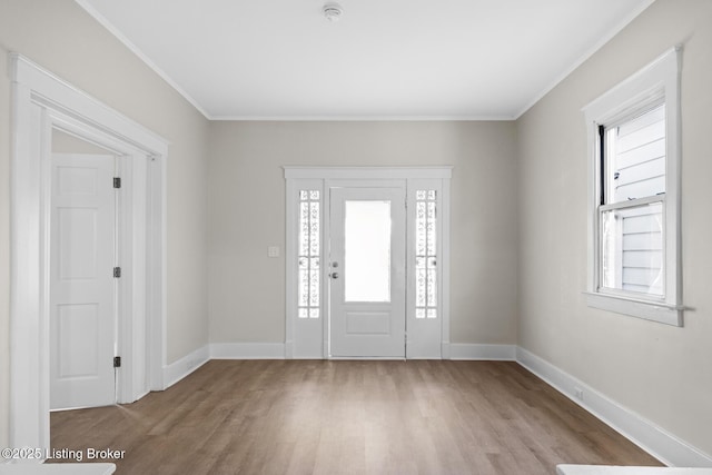 foyer featuring crown molding and light hardwood / wood-style floors