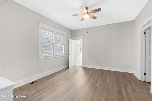 unfurnished bedroom with crown molding, light hardwood / wood-style floors, and ceiling fan