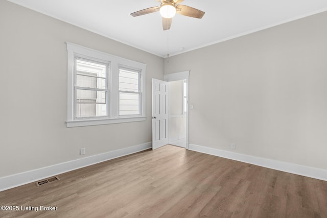 spare room featuring ceiling fan, ornamental molding, and light hardwood / wood-style floors