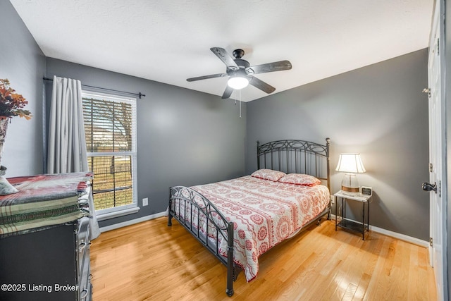 bedroom featuring hardwood / wood-style flooring and ceiling fan