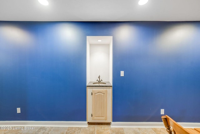 unfurnished room featuring indoor wet bar