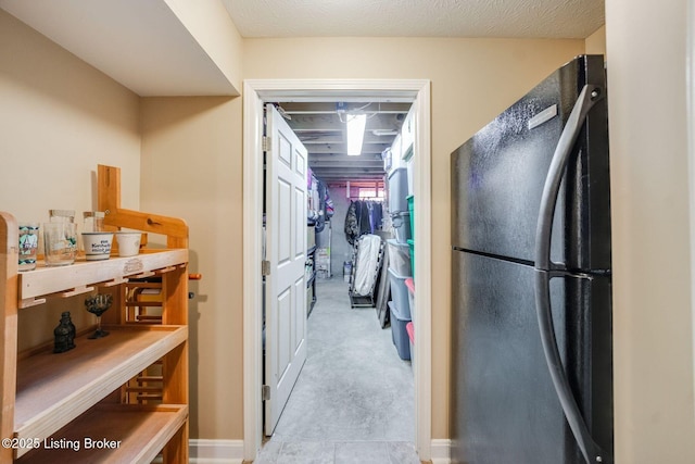 kitchen featuring black refrigerator and light colored carpet