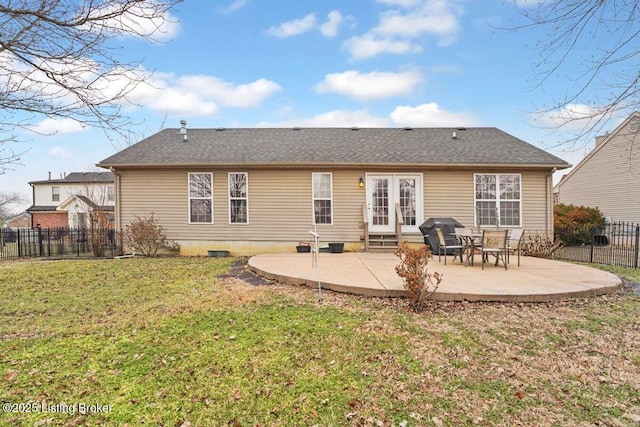 back of property with a yard and a patio area