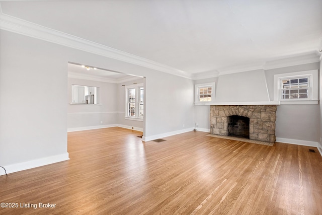 unfurnished living room with a fireplace, light hardwood / wood-style flooring, and ornamental molding