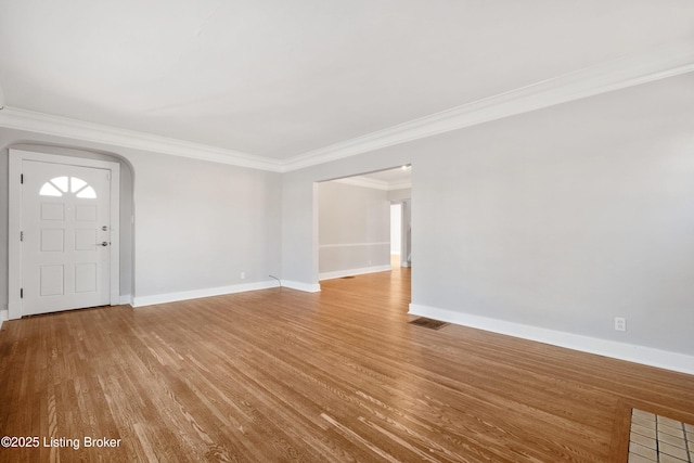 entryway featuring ornamental molding and light hardwood / wood-style floors