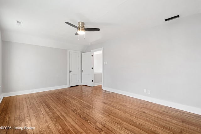 spare room with hardwood / wood-style flooring and ceiling fan