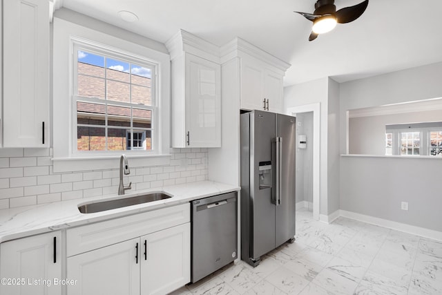 kitchen featuring stainless steel appliances, white cabinetry, and sink