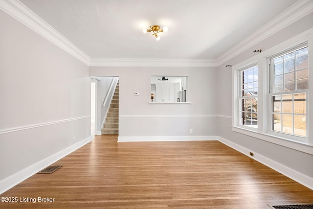 unfurnished living room featuring ornamental molding and hardwood / wood-style floors