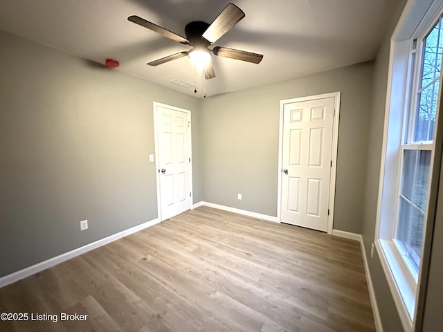 unfurnished bedroom featuring ceiling fan and hardwood / wood-style floors