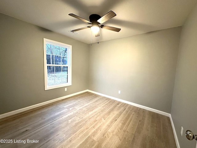 empty room with wood-type flooring and ceiling fan