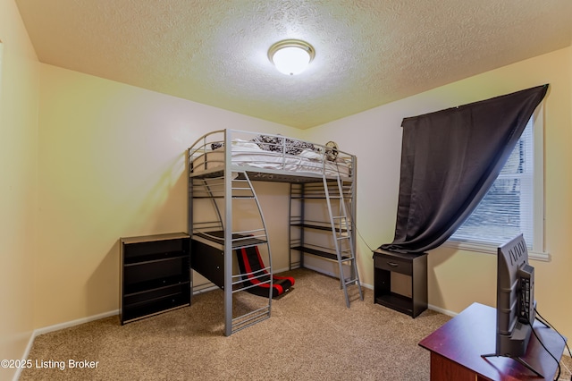 carpeted bedroom featuring a textured ceiling