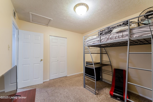 bedroom featuring a textured ceiling and carpet flooring