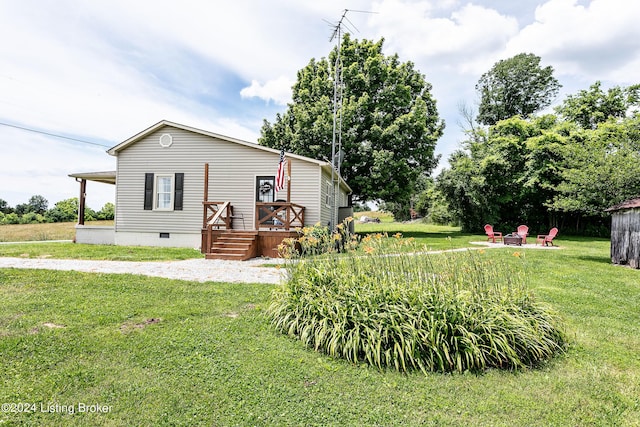 view of front of house with a fire pit and a front yard