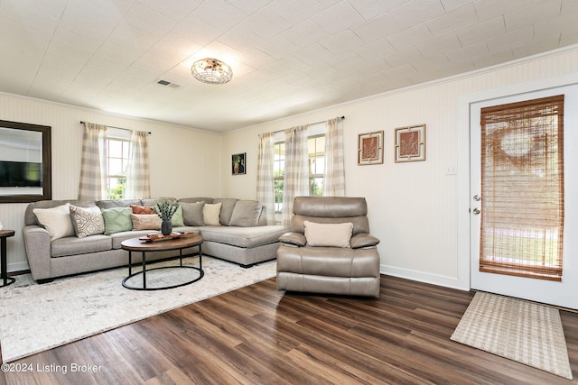 living room featuring crown molding and dark hardwood / wood-style flooring