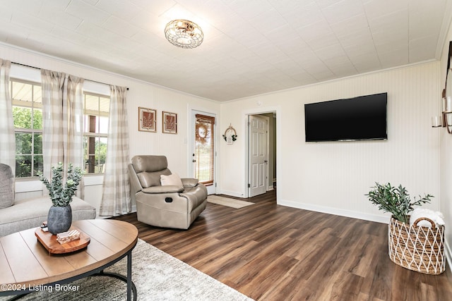 living room featuring dark hardwood / wood-style flooring and ornamental molding