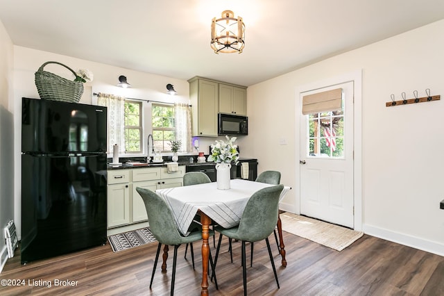 dining area featuring dark hardwood / wood-style floors and sink